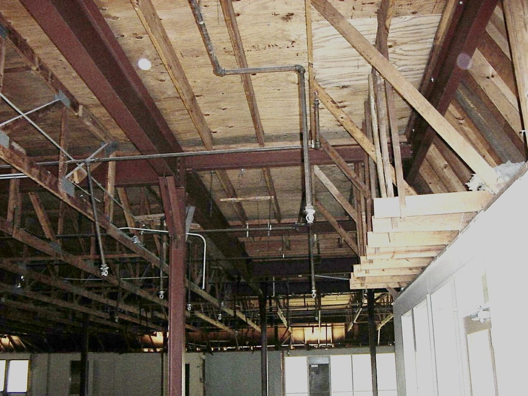 Gutted building interior showing exposed wooden beams and steel structure