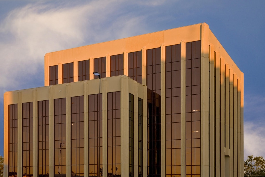 Office tower at sunset with reflective windows