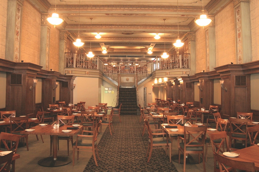 Elegant historic Diamond Grill dining hall interior with ornate balcony and warm lighting