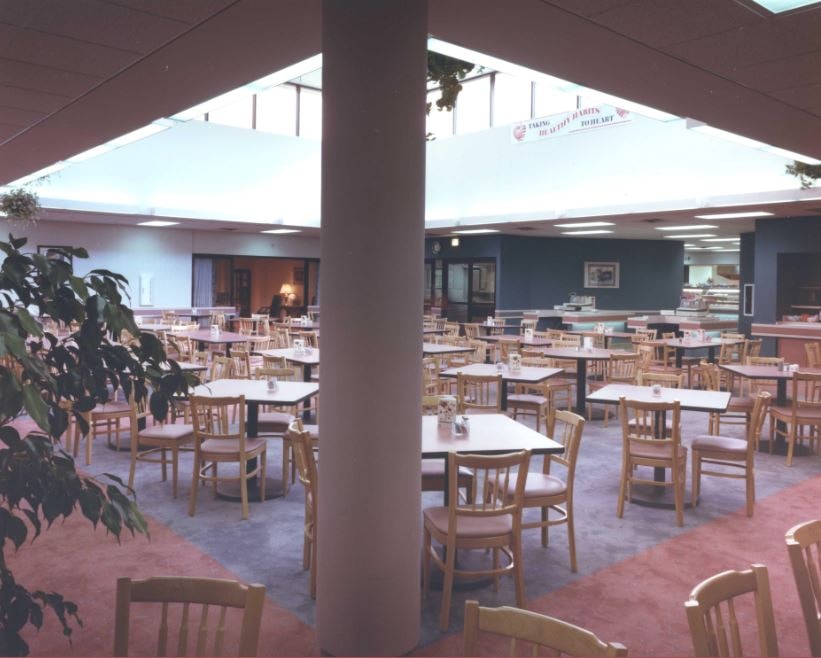 Hospital cafeteria dining room with tables and chairs