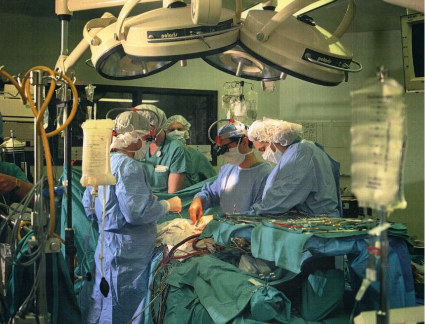 Surgical team performing operation in operating room